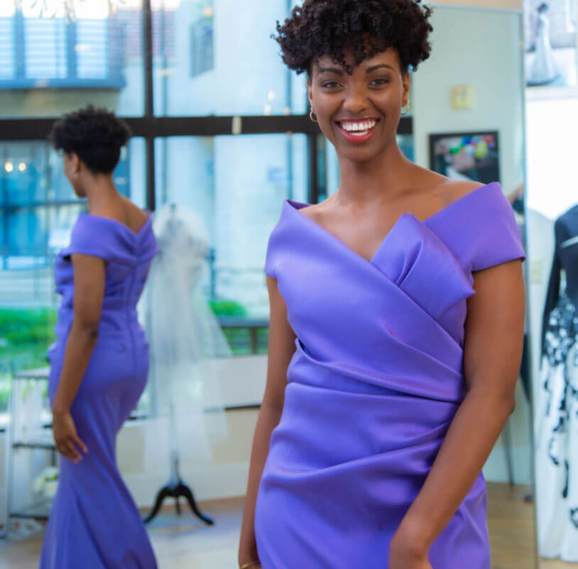 Model wearing a purple evening Collection Gown