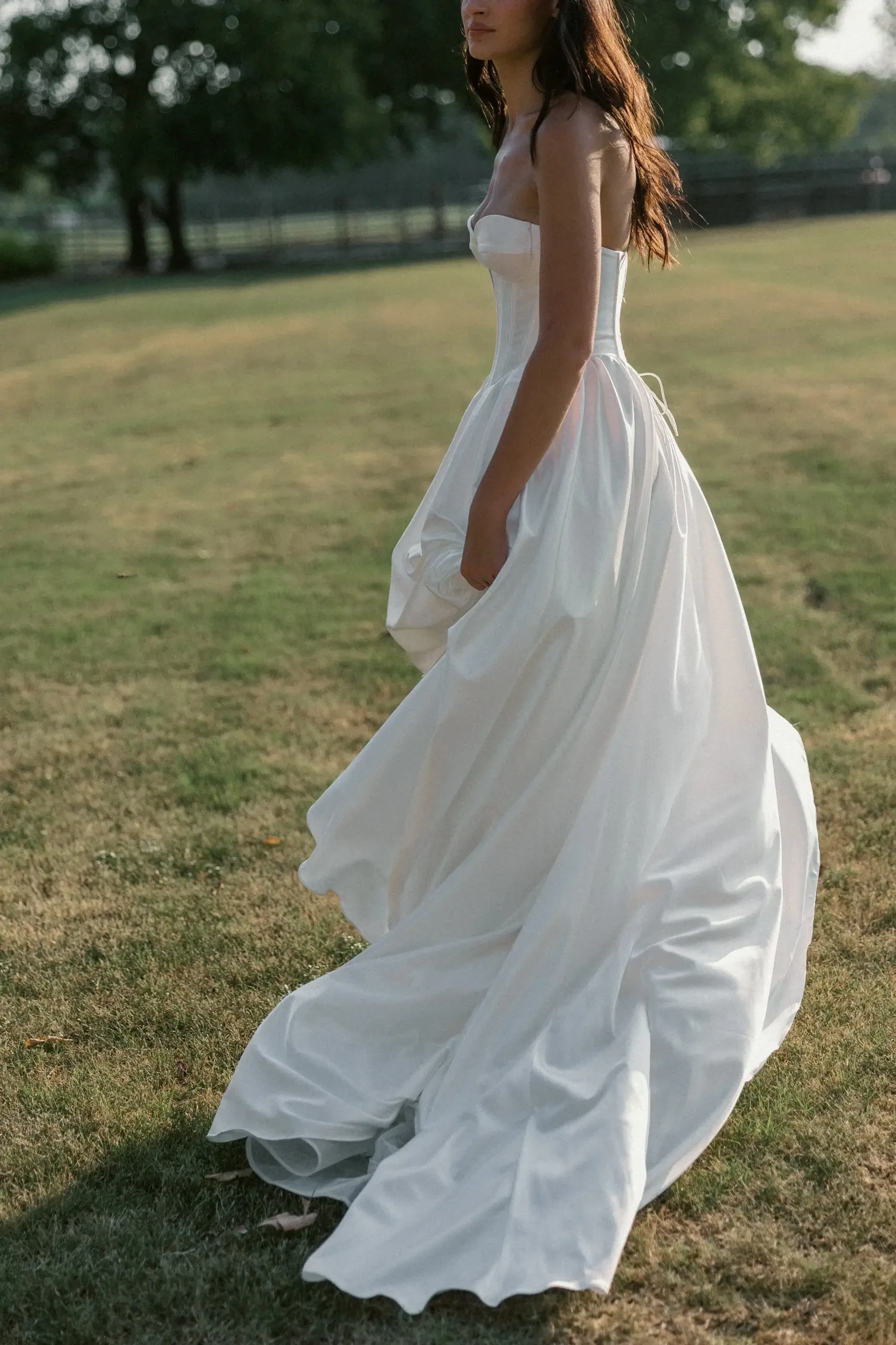 model is wearing a strapless a-line bridal gown