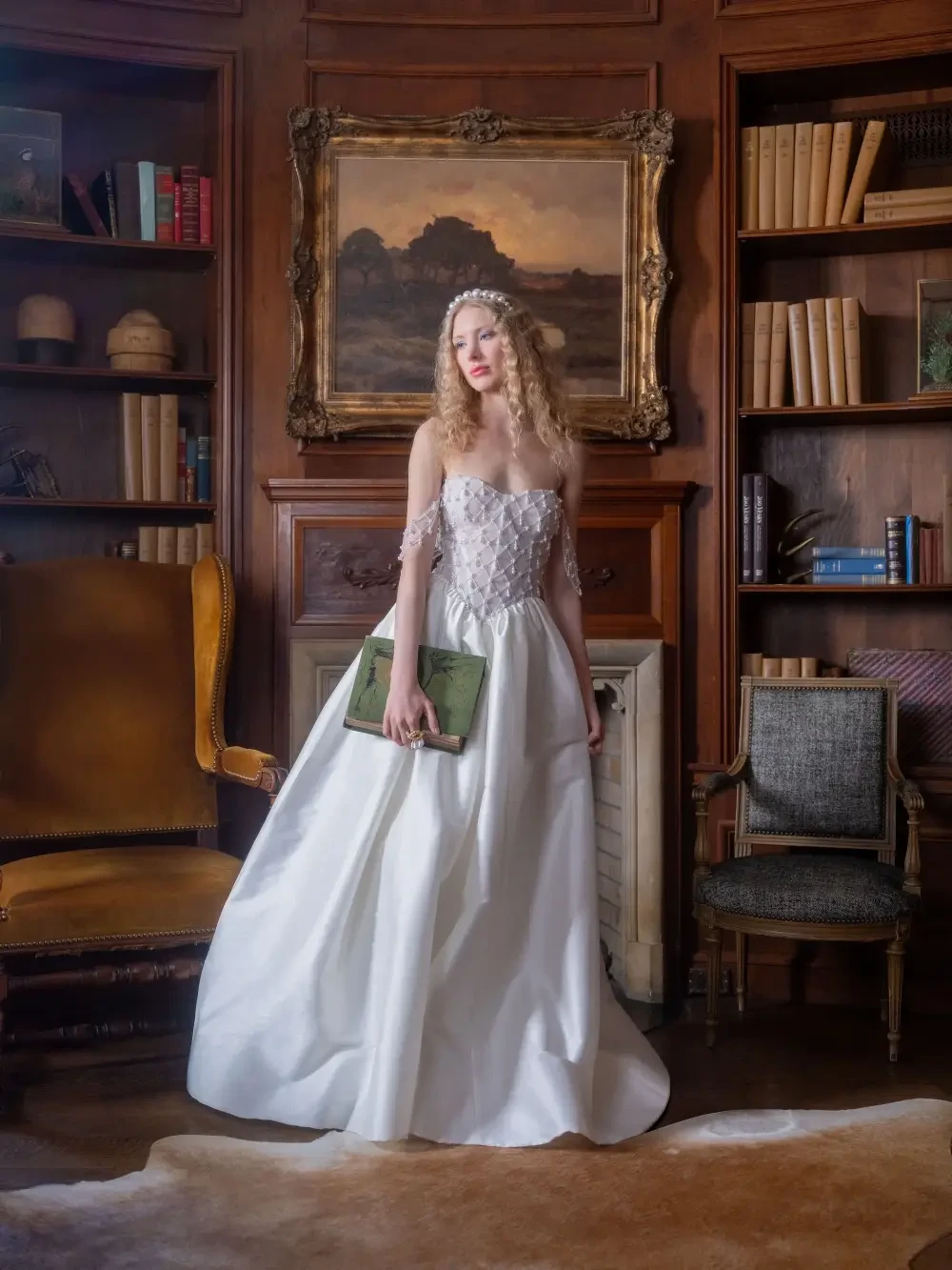 A bride in a white wedding dress poses in a vintage library setting with bookshelves and elegant furniture.