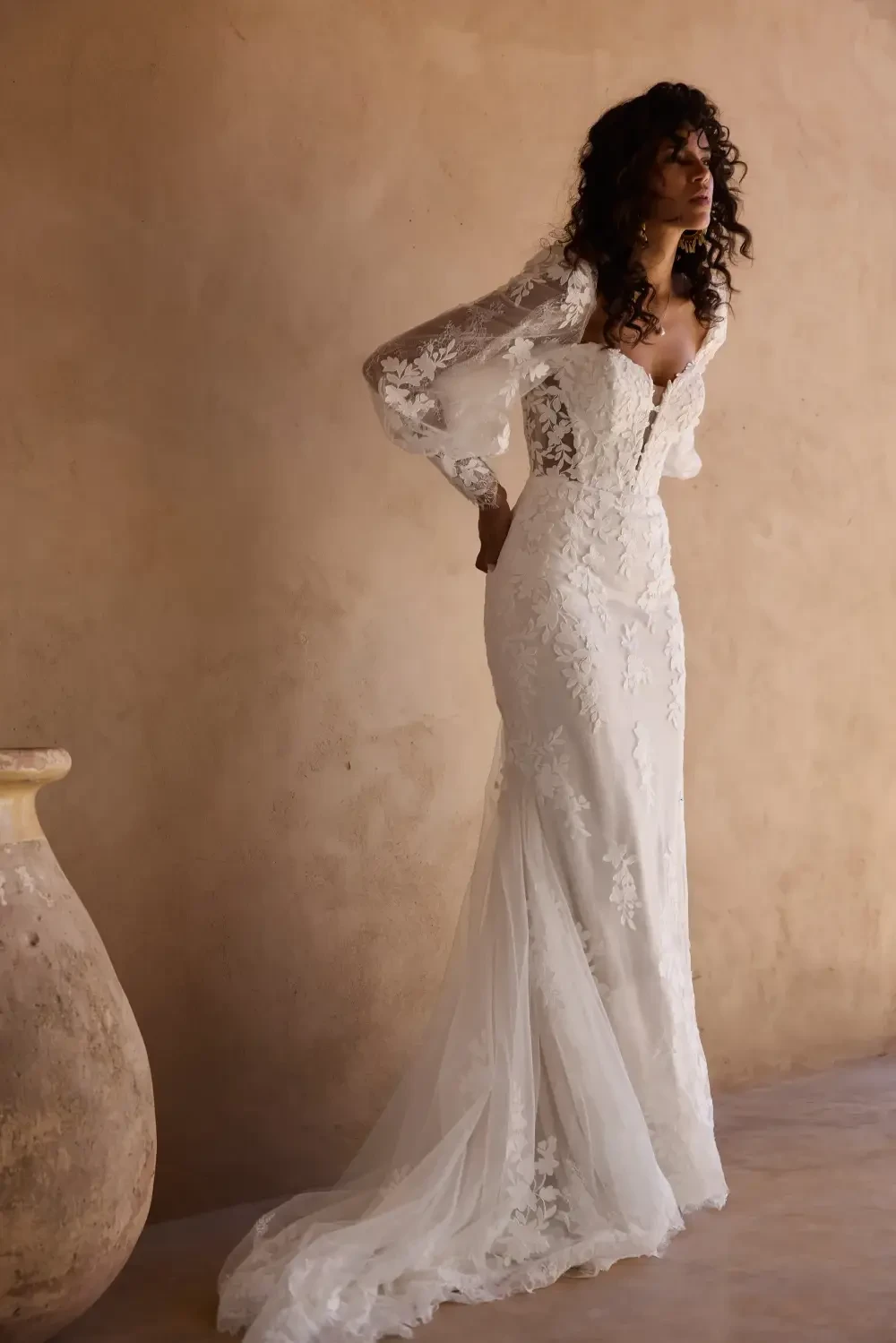 model is wearing a lace bridal gown