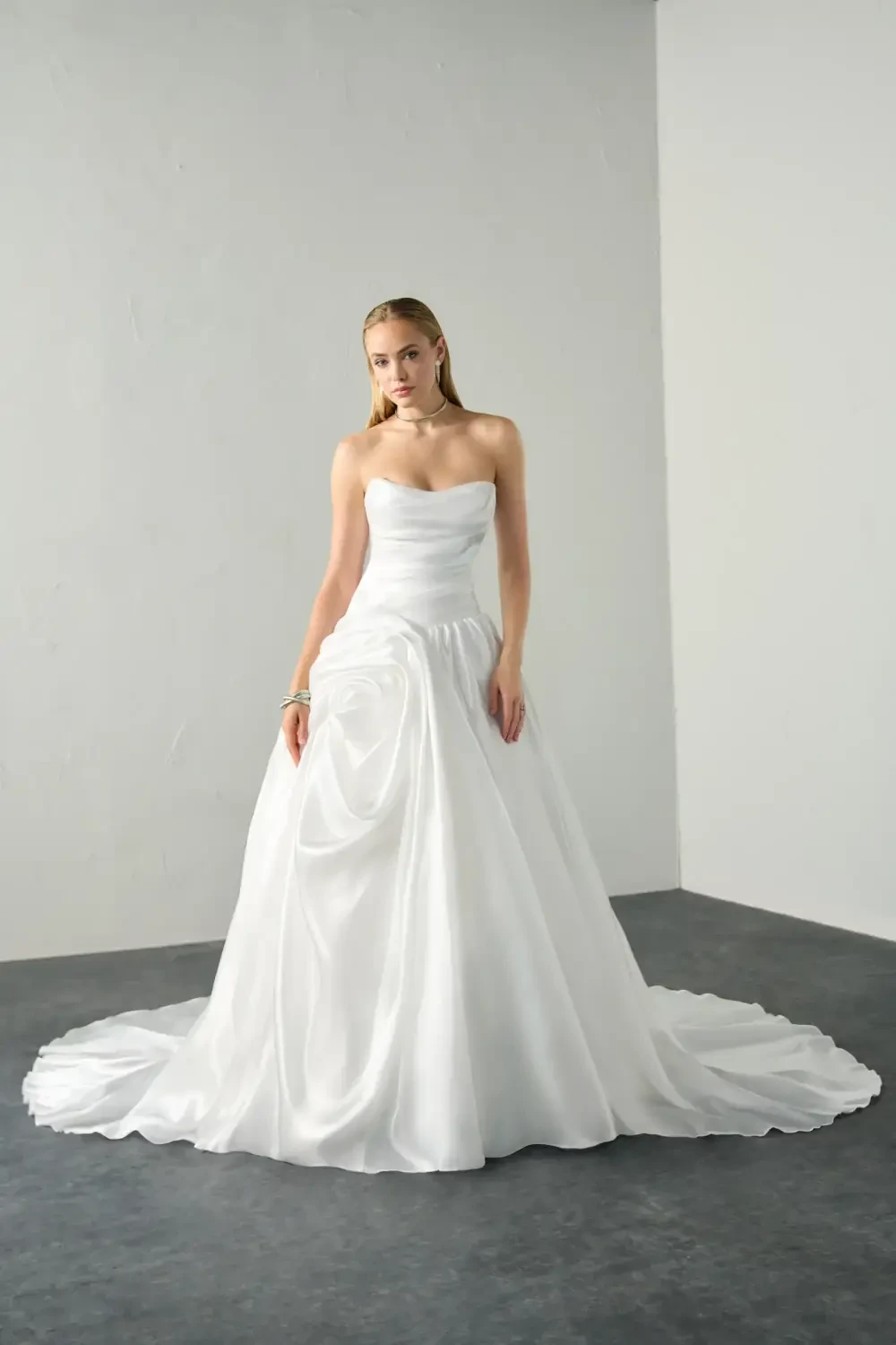 model is wearing a strapless a-line bridal gown