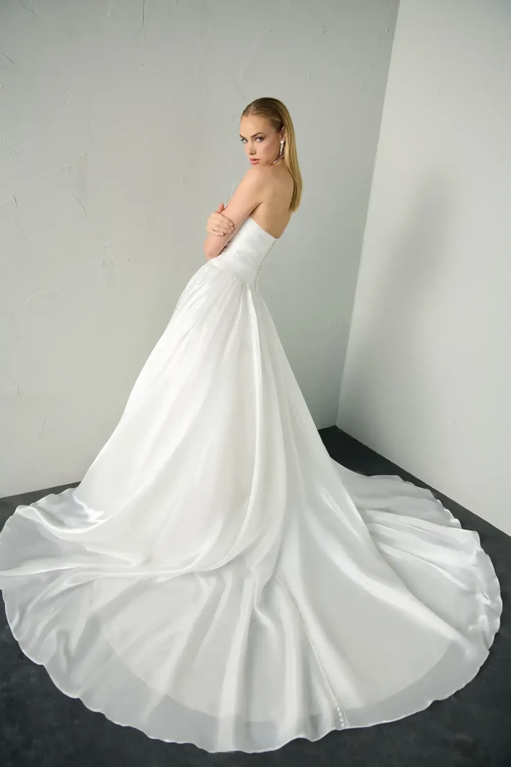 model is wearing a strapless a-line bridal gown
