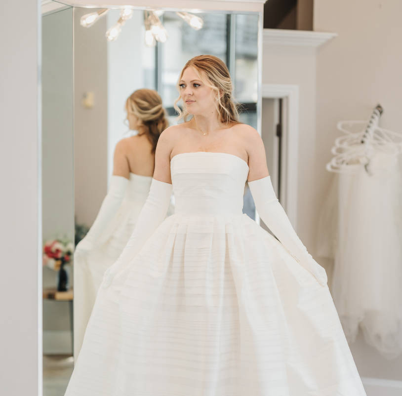 Model wearing a white debutante Collection Gown