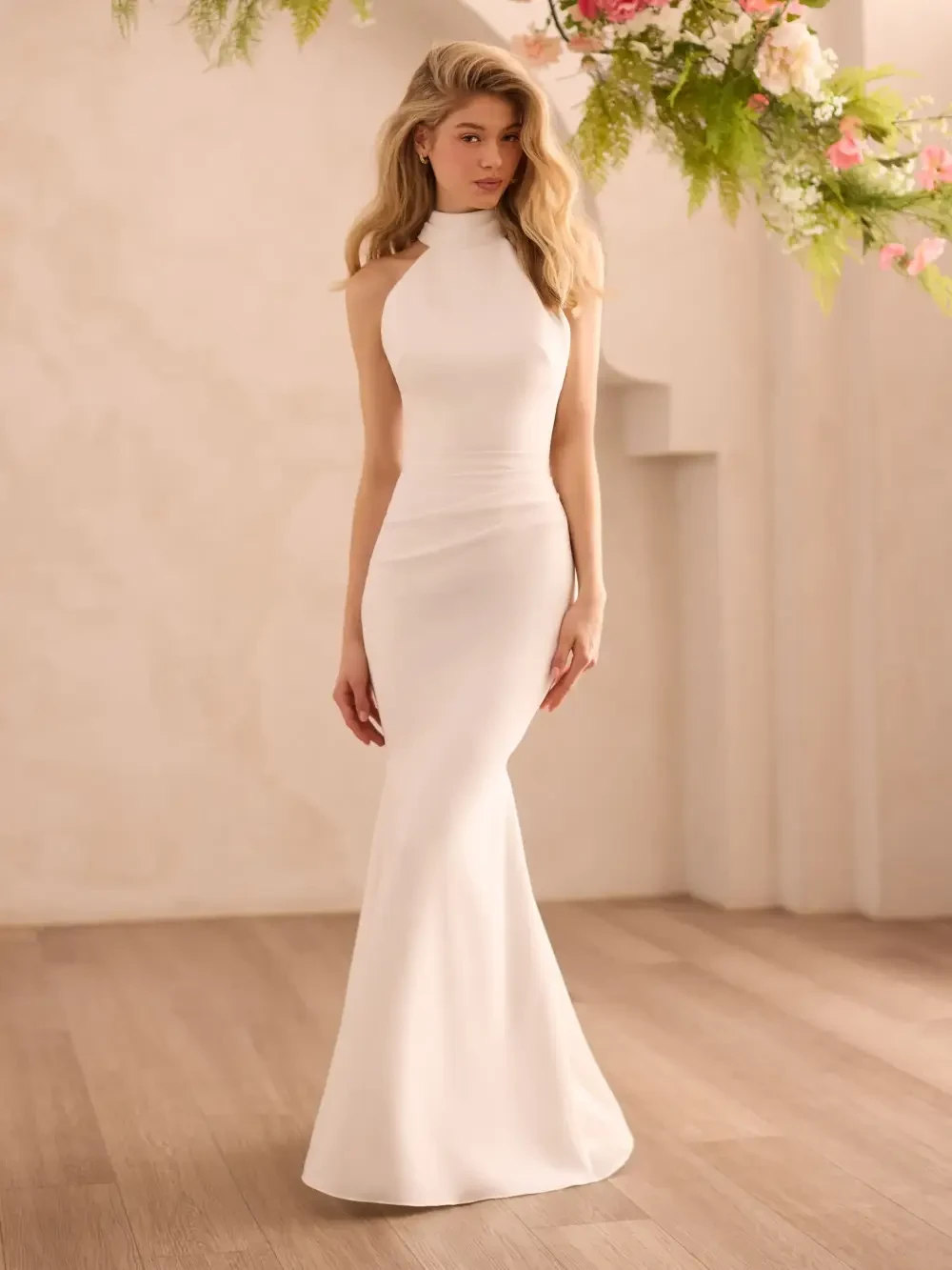 model is wearing a sleeveless halter high neck wedding dress