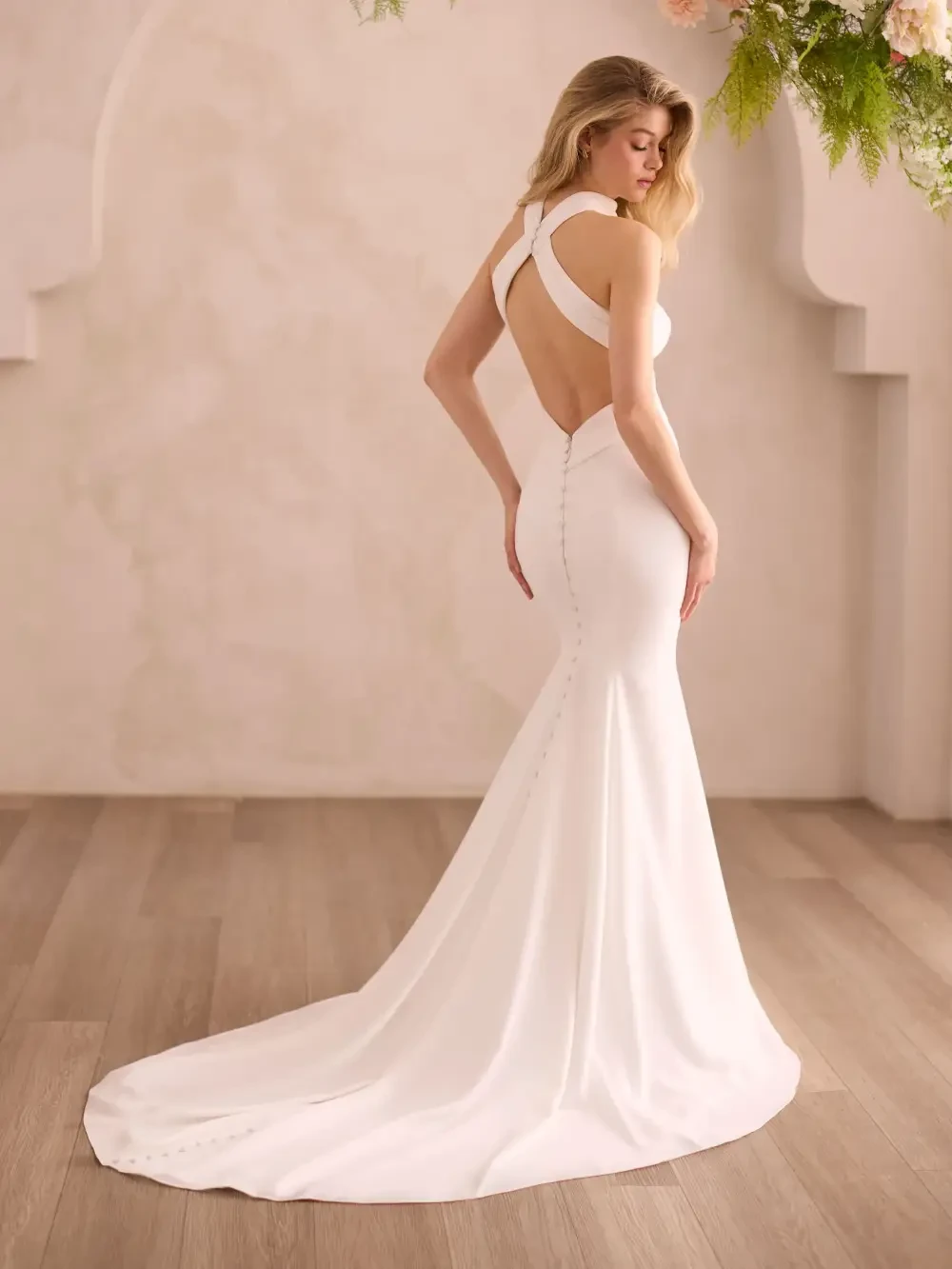 model is wearing a sleeveless halter high neck wedding dress