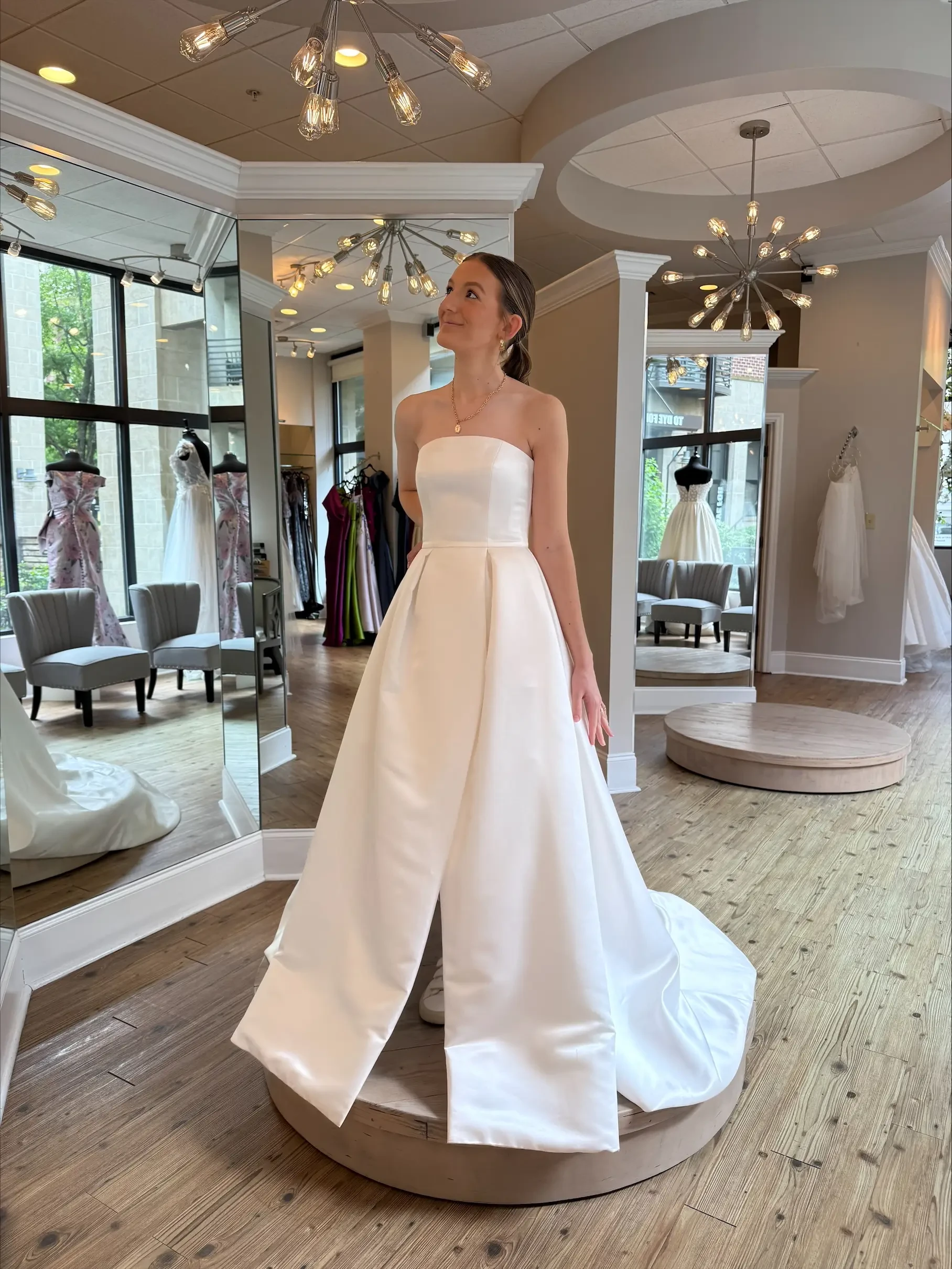 Model is wearing a strapless ball gown wedding dress