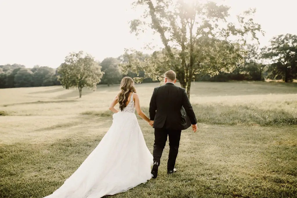 Сouple wearing a white gown and a black suit