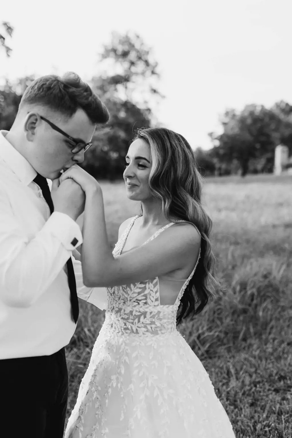 Сouple wearing a white gown and a black suit